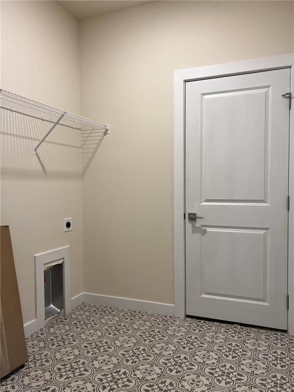 152 Mcpherson Rd, South Mills, NC 27976 - clothes washing area featuring tile patterned floors, electric dryer hookup, laundry area, and baseboards