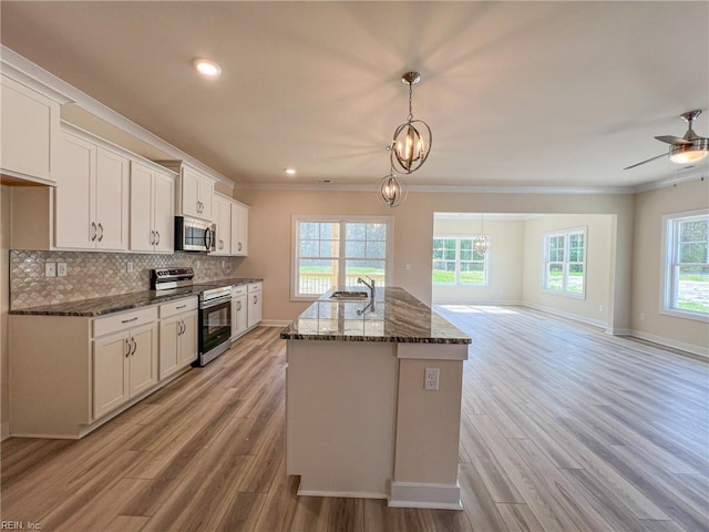 152 Mcpherson Rd, South Mills, NC 27976 - kitchen featuring appliances with stainless steel finishes, light wood-type flooring, ornamental molding, and baseboards