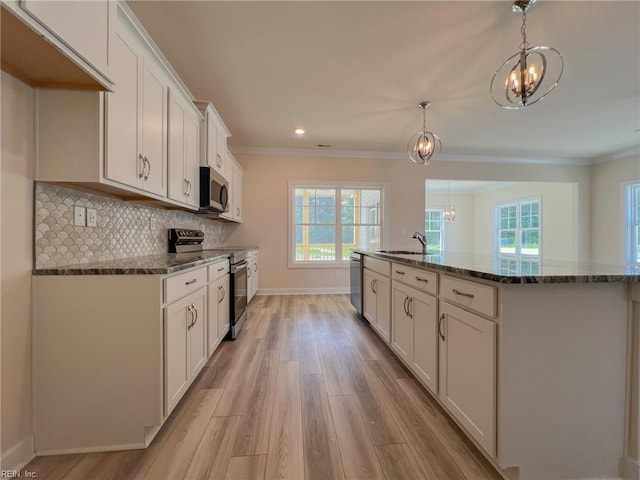 152 Mcpherson Rd, South Mills, NC 27976 - kitchen featuring a chandelier, baseboards, light wood-style floors, and appliances with stainless steel finishes
