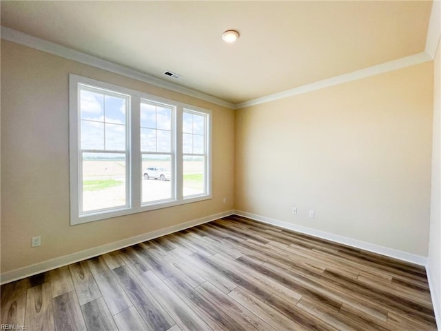 152 Mcpherson Rd, South Mills, NC 27976 - unfurnished room featuring wood finished floors, visible vents, ornamental molding, and baseboards