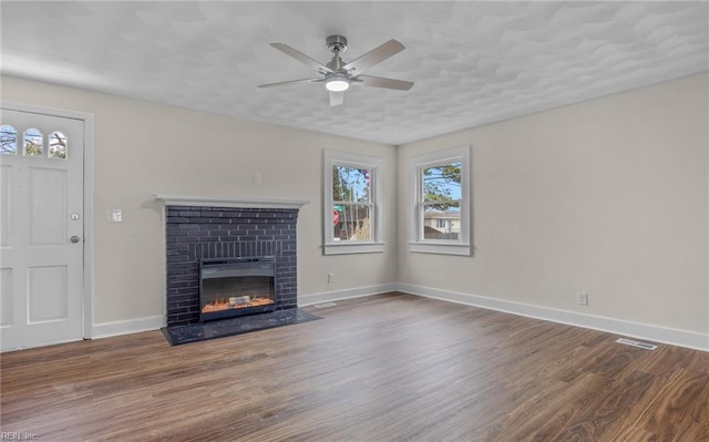 9254 Marlow Ave, Norfolk, VA 23503 - unfurnished living room featuring visible vents, ceiling fan, wood finished floors, and a healthy amount of sunlight