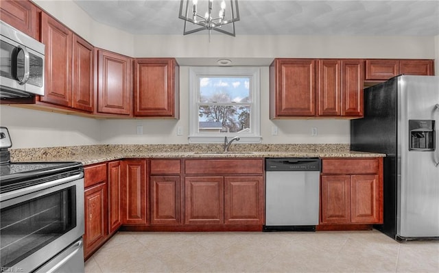 9254 Marlow Ave, Norfolk, VA 23503 - kitchen with an inviting chandelier, light stone counters, a sink, light tile patterned floors, and stainless steel appliances