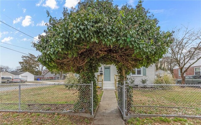 9254 Marlow Ave, Norfolk, VA 23503 - view of property hidden behind natural elements featuring a fenced front yard, a gate, and a front yard