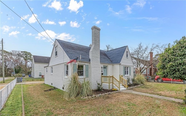 9254 Marlow Ave, Norfolk, VA 23503 - view of side of home featuring brick siding, fence, a yard, and a chimney