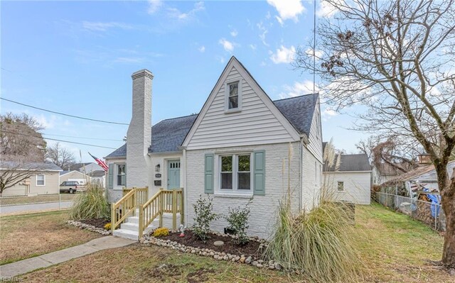 9254 Marlow Ave, Norfolk, VA 23503 - bungalow-style house with a chimney, a front yard, brick siding, fence, and a shingled roof