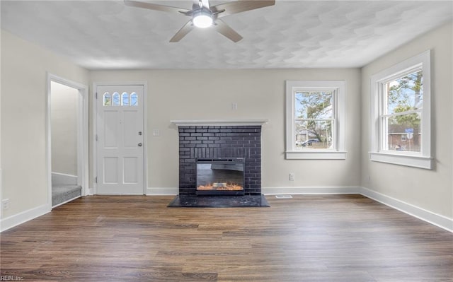 9254 Marlow Ave, Norfolk, VA 23503 - unfurnished living room with baseboards, ceiling fan, wood finished floors, and a fireplace