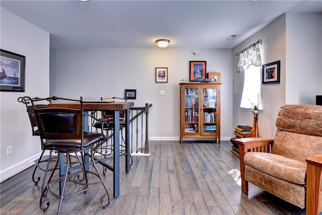 dining room with baseboards, wood finished floors, and visible vents