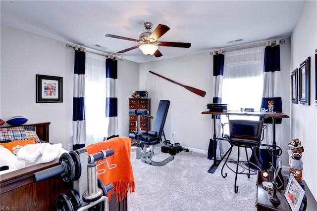 interior space with a ceiling fan, baseboards, and visible vents