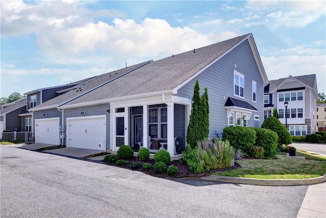view of home's exterior featuring roof with shingles and a garage