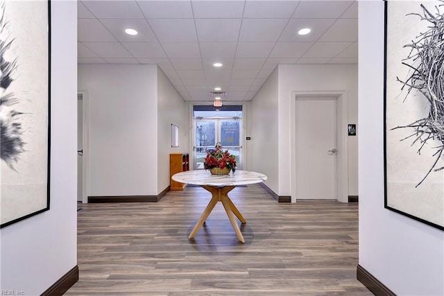 hallway with baseboards, recessed lighting, and wood finished floors