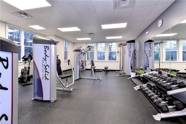 workout area with visible vents and a drop ceiling