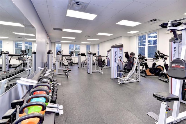 workout area featuring visible vents and a paneled ceiling