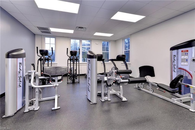 gym with a drop ceiling and visible vents