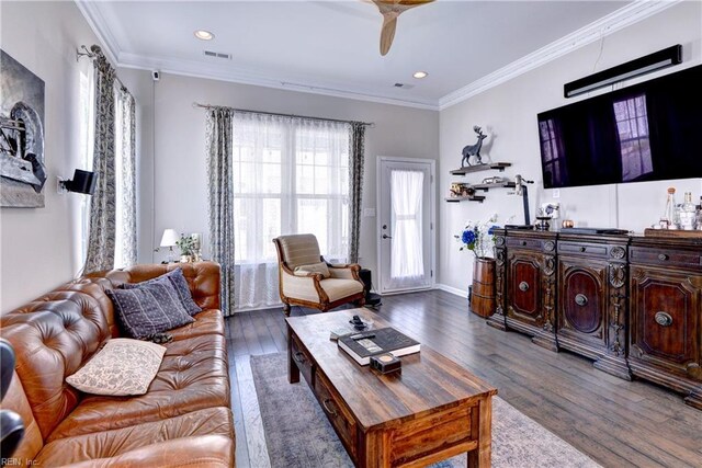 living area featuring crown molding, ceiling fan, wood finished floors, and visible vents