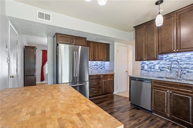 110 Greenwell Dr, Hampton, VA 23666 - kitchen with a sink, wood counters, stainless steel appliances, tasteful backsplash, and visible vents