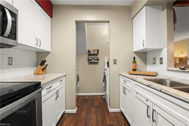 kitchen with light stone countertops, white cabinets, tasteful backsplash, dark wood finished floors, and appliances with stainless steel finishes