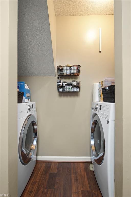 laundry area featuring laundry area, baseboards, and wood finished floors