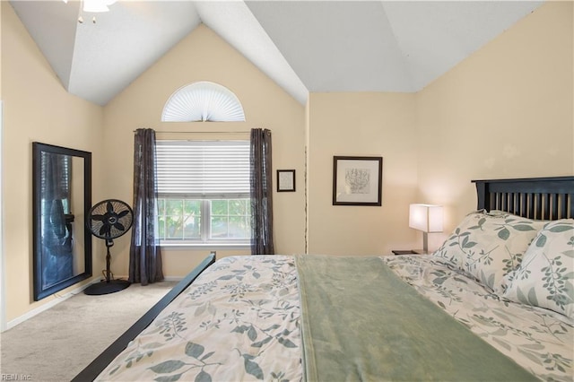 carpeted bedroom with baseboards and vaulted ceiling