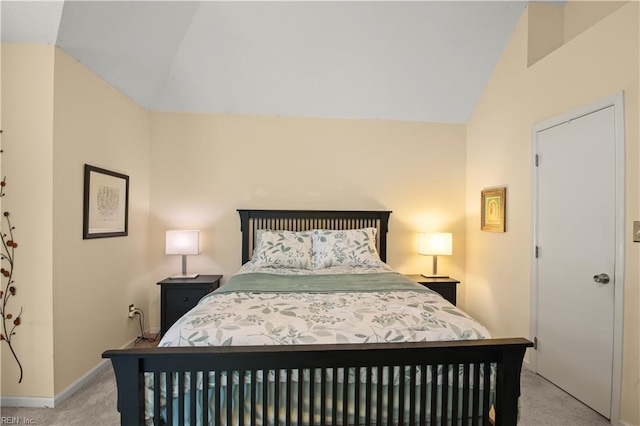 bedroom with baseboards, light colored carpet, and lofted ceiling