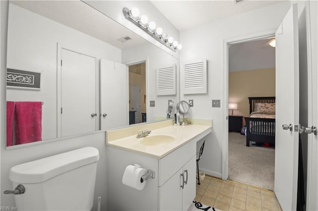 bathroom featuring toilet, ensuite bath, and vanity