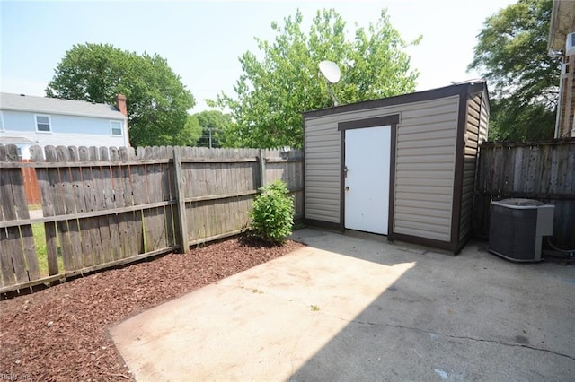 view of shed featuring a fenced backyard and central air condition unit