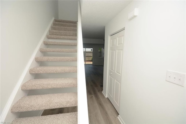 staircase featuring wood finished floors