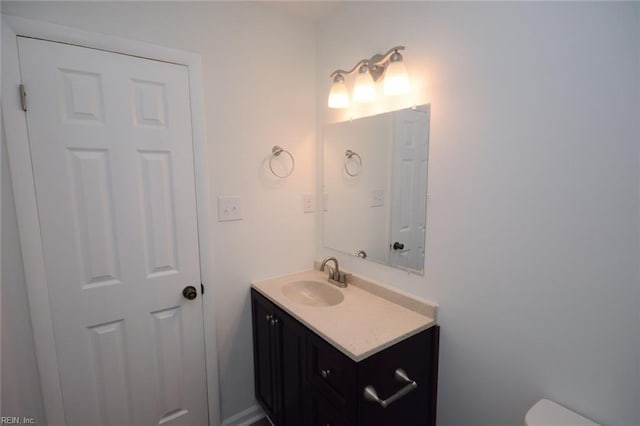 half bathroom with toilet and vanity