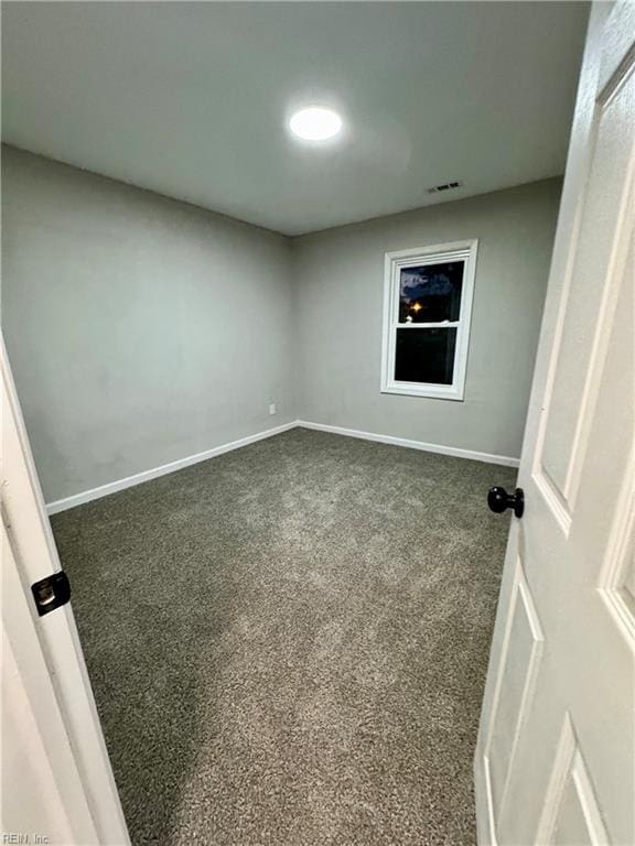 empty room with visible vents, carpet, and baseboards