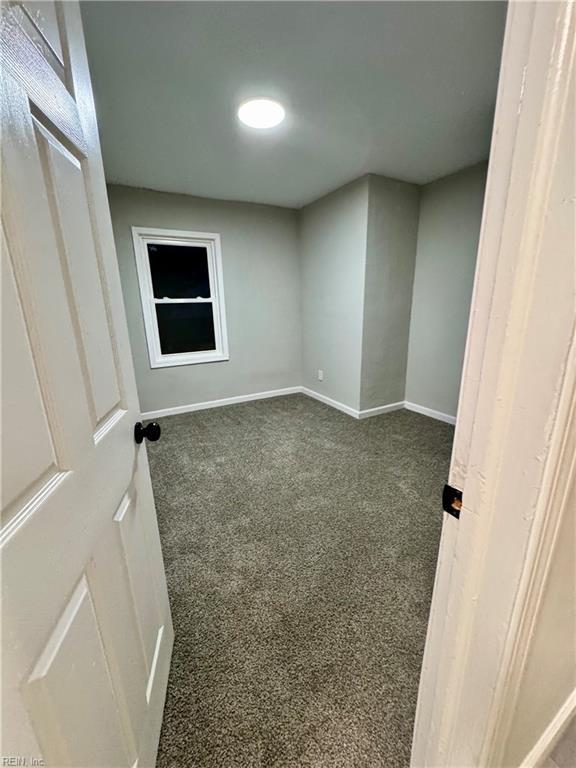 empty room with carpet flooring and baseboards