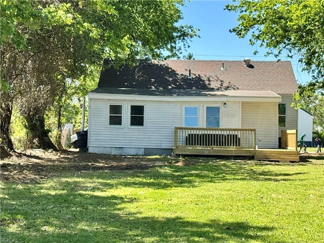 back of house with roof with shingles, a wooden deck, a yard, and crawl space
