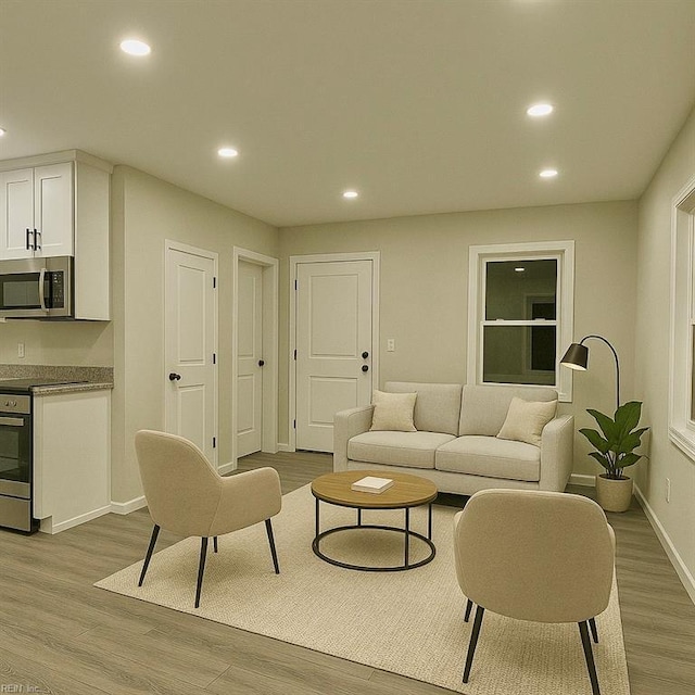 living area with baseboards, recessed lighting, and wood finished floors