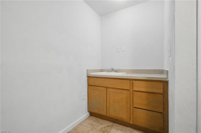 bathroom with baseboards and vanity