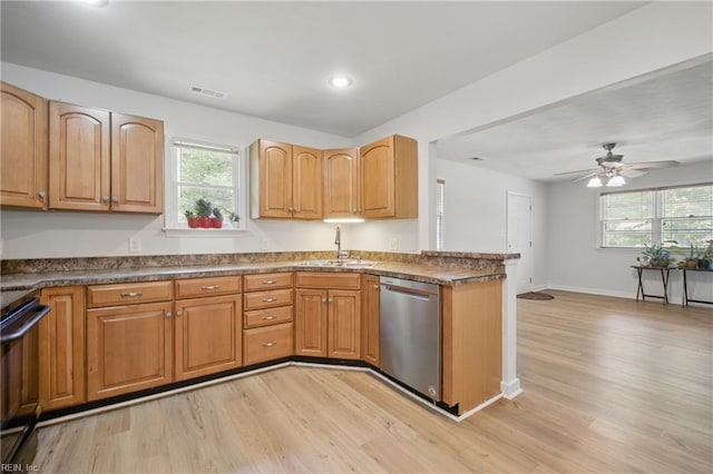 kitchen featuring visible vents, light wood-style floors, electric stove, a sink, and dishwasher