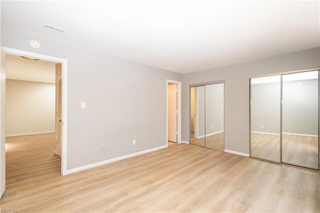 1103 Black Duck Ct, Virginia Beach, VA 23451 - unfurnished bedroom featuring baseboards, two closets, light wood-type flooring, and visible vents