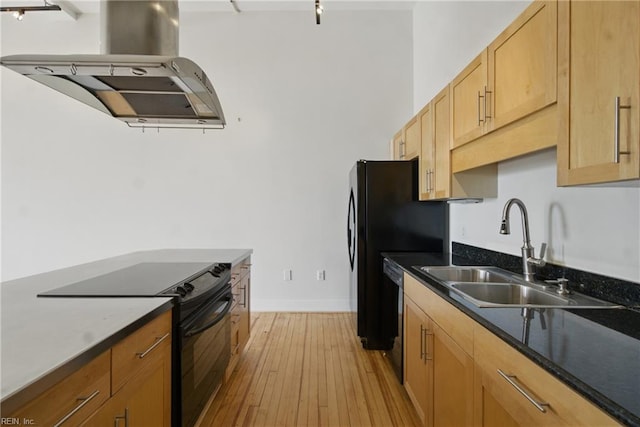kitchen with a sink, dishwasher, black electric range, island exhaust hood, and light wood-type flooring