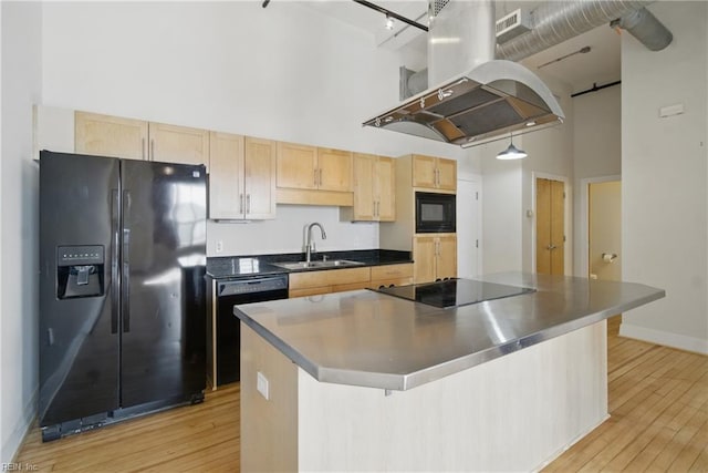 kitchen with island exhaust hood, a sink, black appliances, light brown cabinets, and a high ceiling