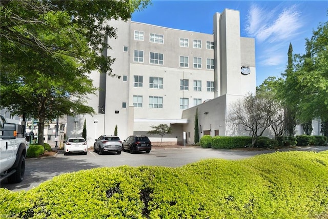 view of property featuring uncovered parking