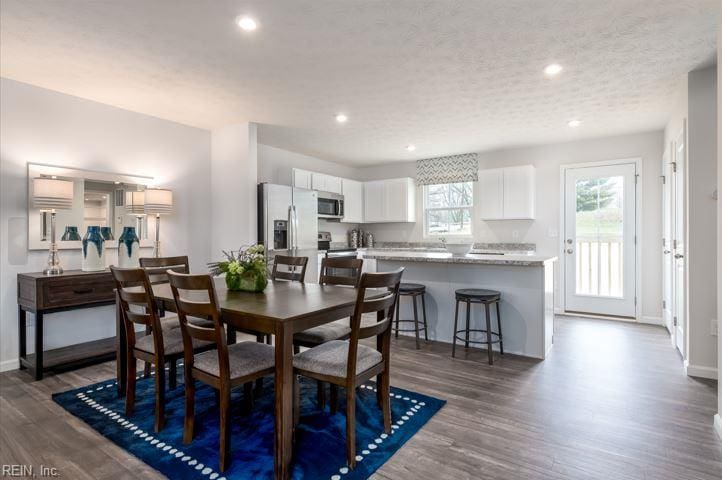 dining space featuring recessed lighting, dark wood finished floors, and baseboards