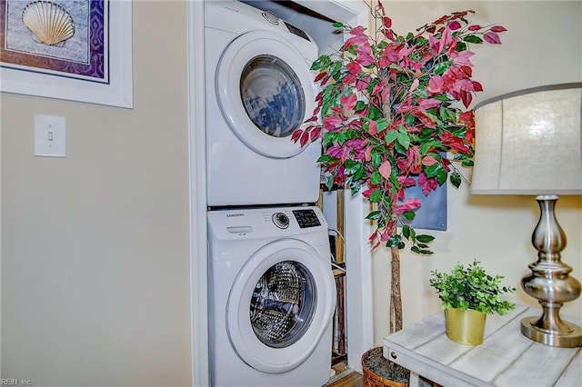 laundry room with stacked washing maching and dryer and laundry area