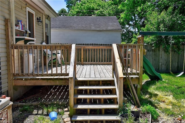 deck with a playground and fence