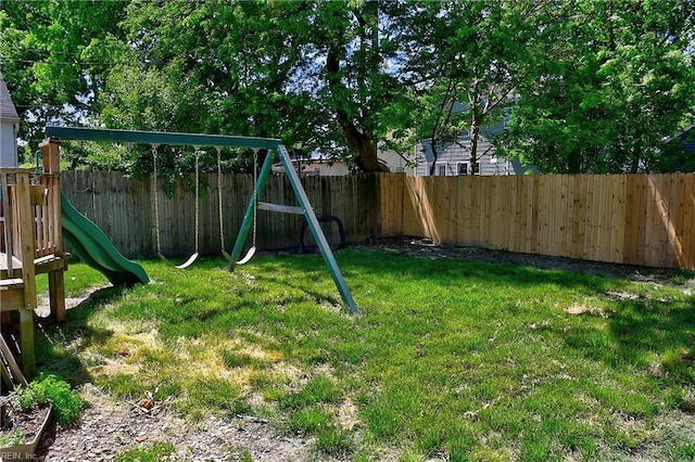 view of jungle gym with a lawn and a fenced backyard