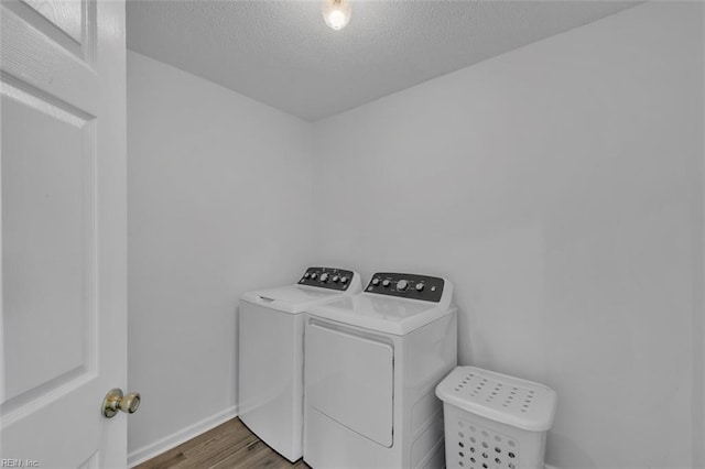 157 Pier Lndg, South Mills, NC 27976 - laundry room with washer and dryer, laundry area, a textured ceiling, baseboards, and wood finished floors