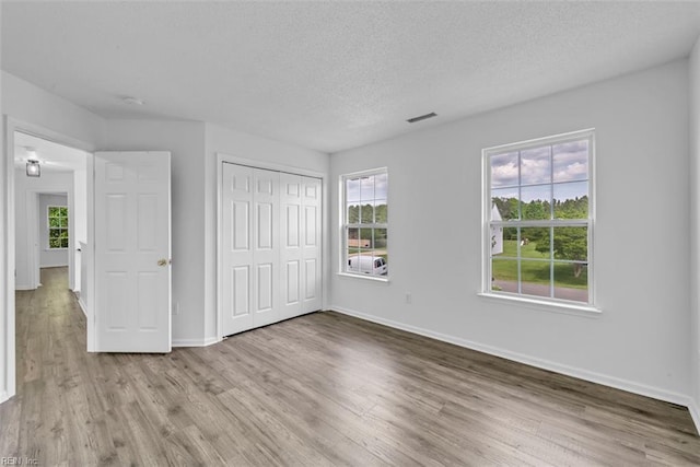 157 Pier Lndg, South Mills, NC 27976 - unfurnished bedroom featuring baseboards, multiple windows, and wood finished floors
