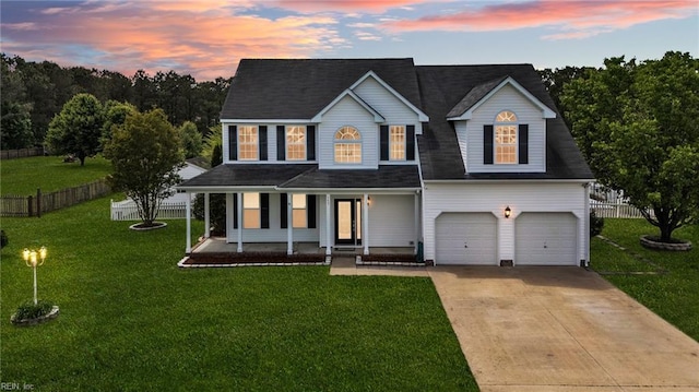 157 Pier Lndg, South Mills, NC 27976 - view of front of house featuring a front lawn, an attached garage, fence, a porch, and driveway