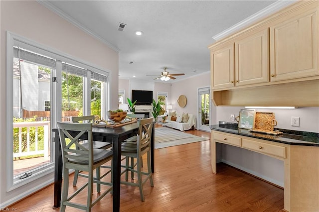 dining space featuring recessed lighting, ornamental molding, light wood finished floors, and visible vents