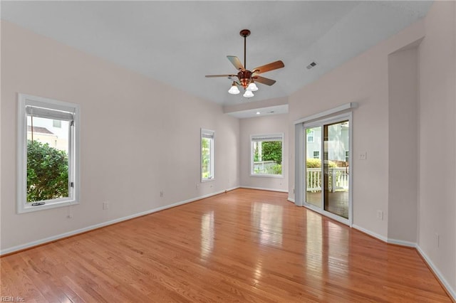 spare room with a ceiling fan, baseboards, visible vents, and light wood-style flooring