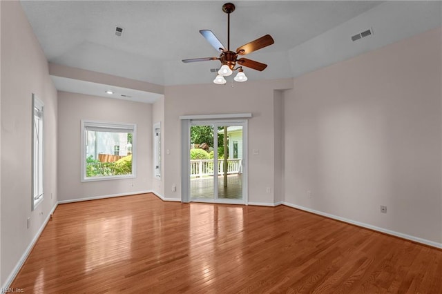 spare room featuring visible vents, baseboards, ceiling fan, and wood finished floors