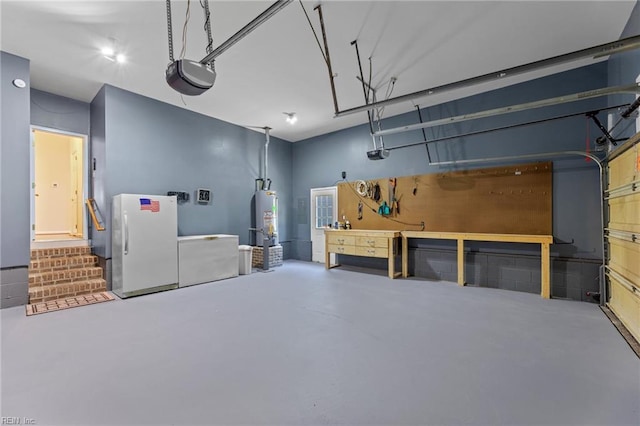 garage with water heater, a workshop area, a garage door opener, and freestanding refrigerator