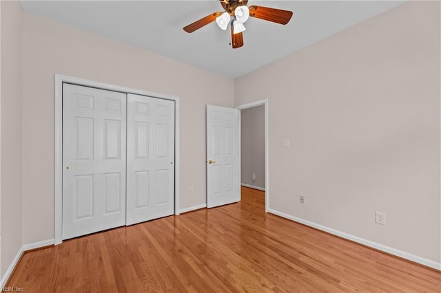 unfurnished bedroom featuring a closet, baseboards, ceiling fan, and light wood-type flooring