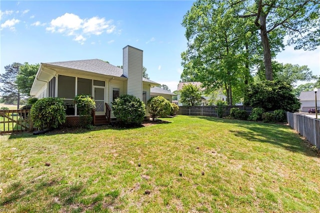 view of yard with a fenced backyard and a sunroom